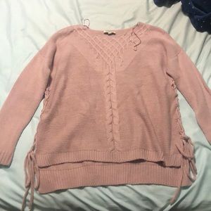 Pink sweater with braided details